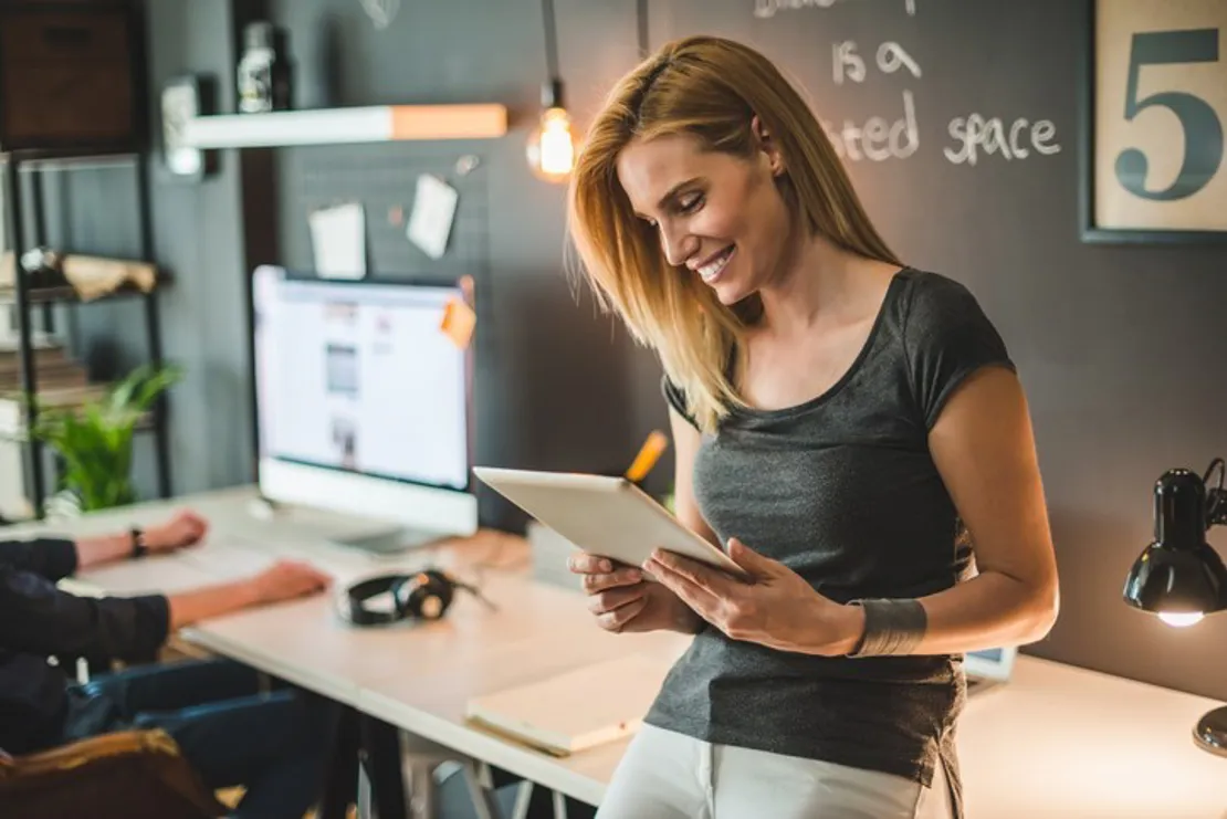 Woman Looking At Tablet At Her Small Business Premises