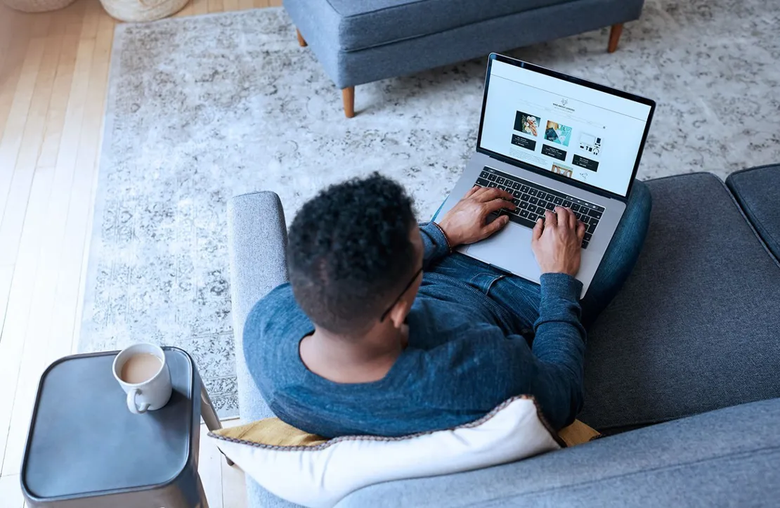 Man sitting on his sofa ordering shopping online