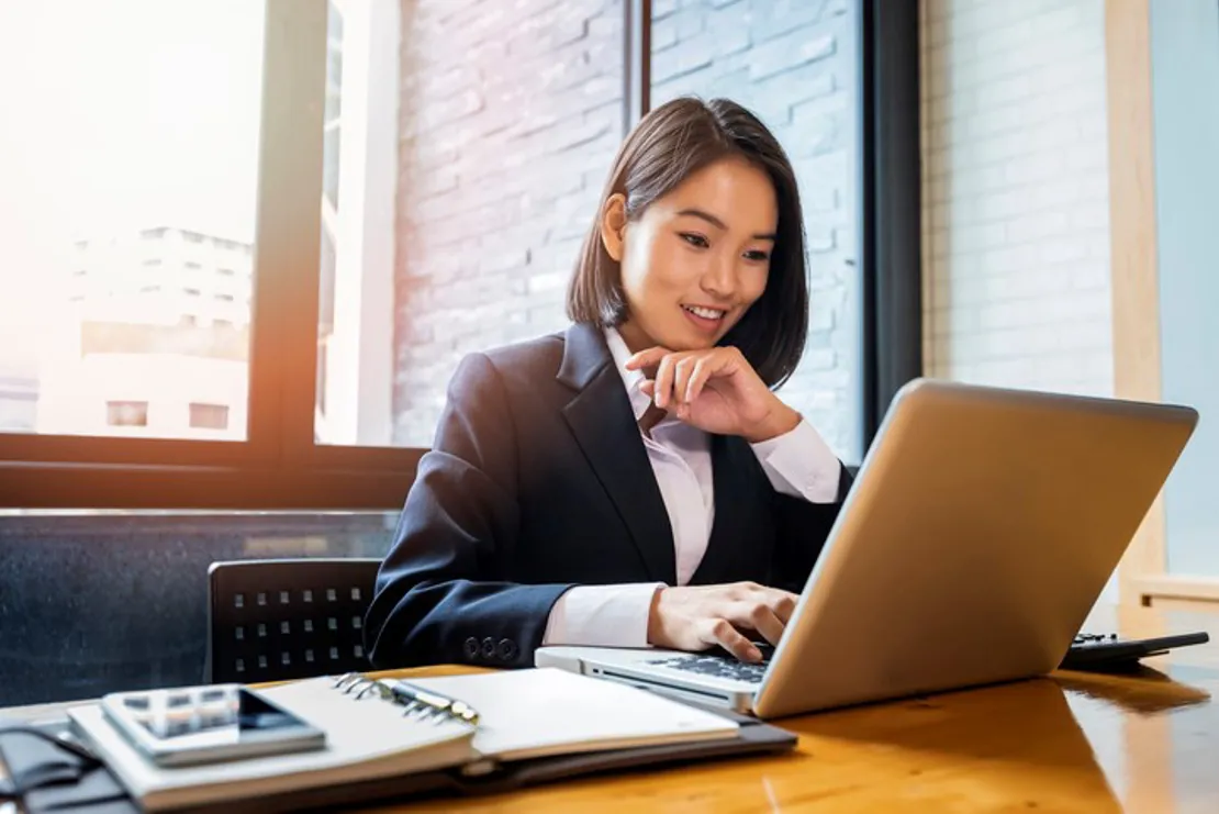 Closeup Of Businesswoman Using Laptop At Office Desk